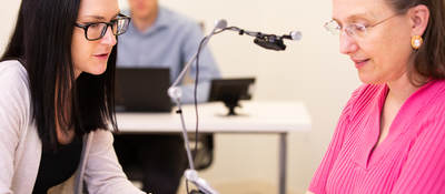 Two people talking in a testing room