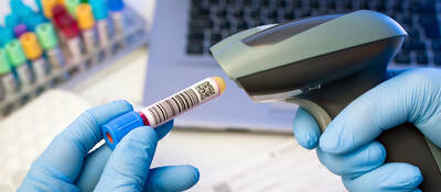Person scanning a QR code on a test tube