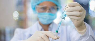 Nurse filling a syringe