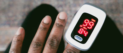 Person using Oximeter on finger