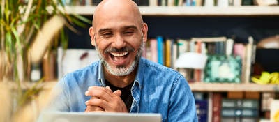 Person clasping hands and smiling