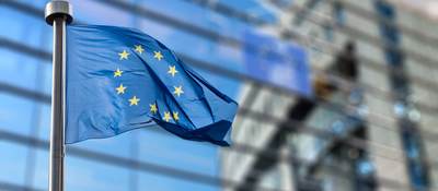 EU flag waving in front of a building