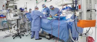 Five surgeons operating on a patient