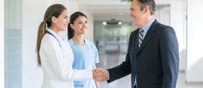 Doctor shaking a person's hand inside a hospital