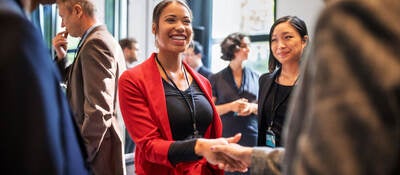 People shaking hands at a business event