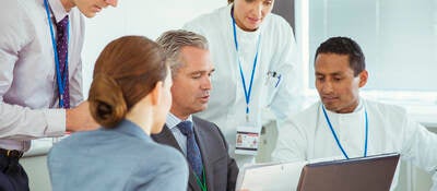 Scientists and business people talking in a conference room