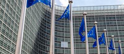 European Union flags flying in front of a building