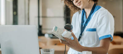 A technician scans the barcodes on medicine boxes