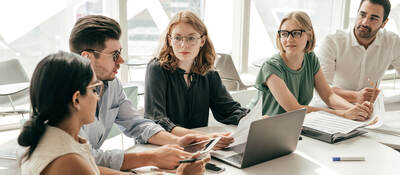 Group of colleagues having a meeting in a contemporary office setting