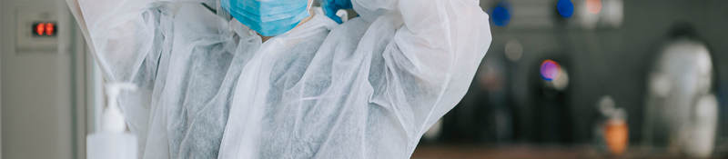 Scientist putting on PPE