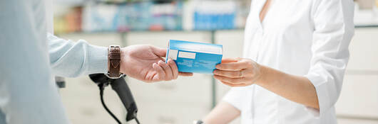 Person purchasing medicine at a pharmacy