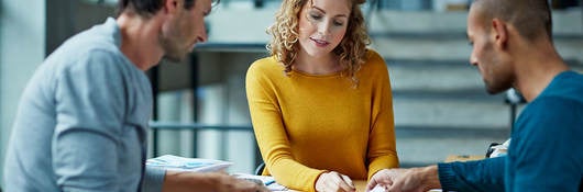 Three people at a table collaborating