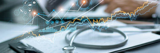 Charts and graphs superimposed over an a medical desk