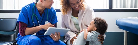 A nurse talking to a mother and child