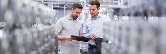 Two people comparing notes in a lab