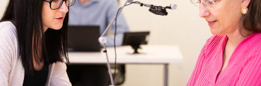 Two people talking in a testing room