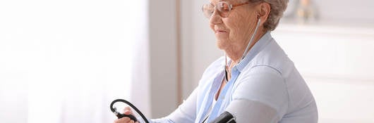 Elderly person measuring their blood pressure