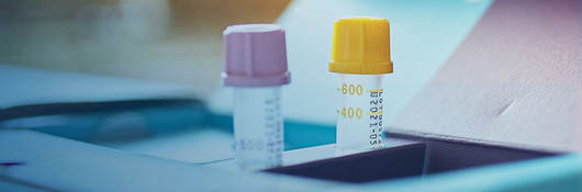 Two test tubes sitting on a desk