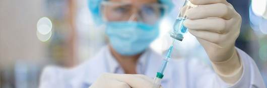 Nurse filling a syringe