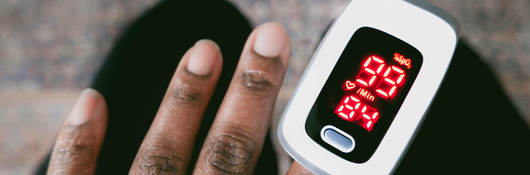 Person using Oximeter on finger