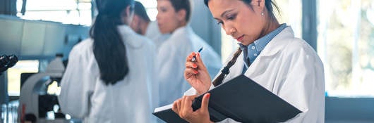 Medical doctor reviewing notes in a book