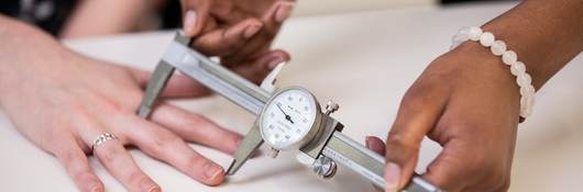 Doctor measuring the length of a patient's finger