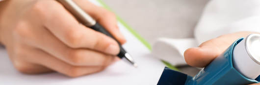 Person taking notes on a clipboard while holding a nebulizer