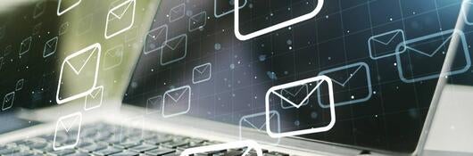 Laptop with email icons graphically overlaid