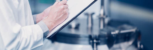 Scientist writing notes on a clipboard