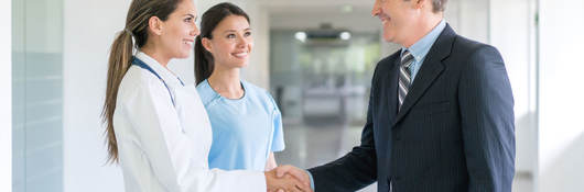 Doctor shaking a person's hand inside a hospital