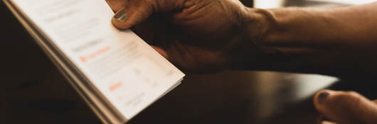 Close up of a hand holding an instruction booklet