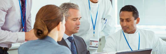 Scientists and business people talking in a conference room