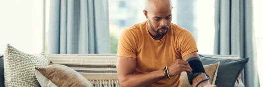 Man trying an at-home blood pressure device