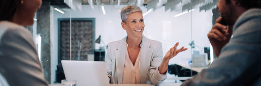 Three business people at a table having a meeting