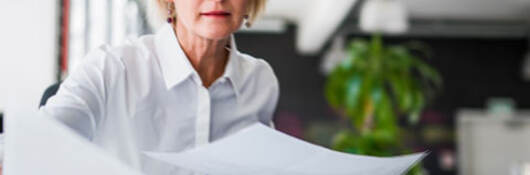 Person laying out papers on a table