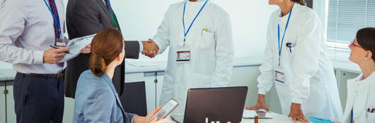 A meeting between business professionals and medical professionals
