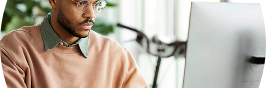 Person sitting at a desk taking an online webinar