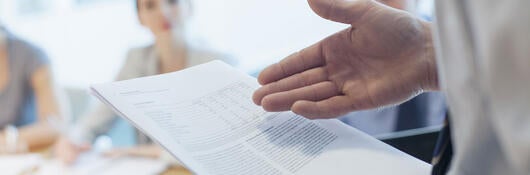 Lawyer presenting new legislation to a group of people in a meeting