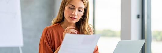 Person in a meeting room reviewing documents