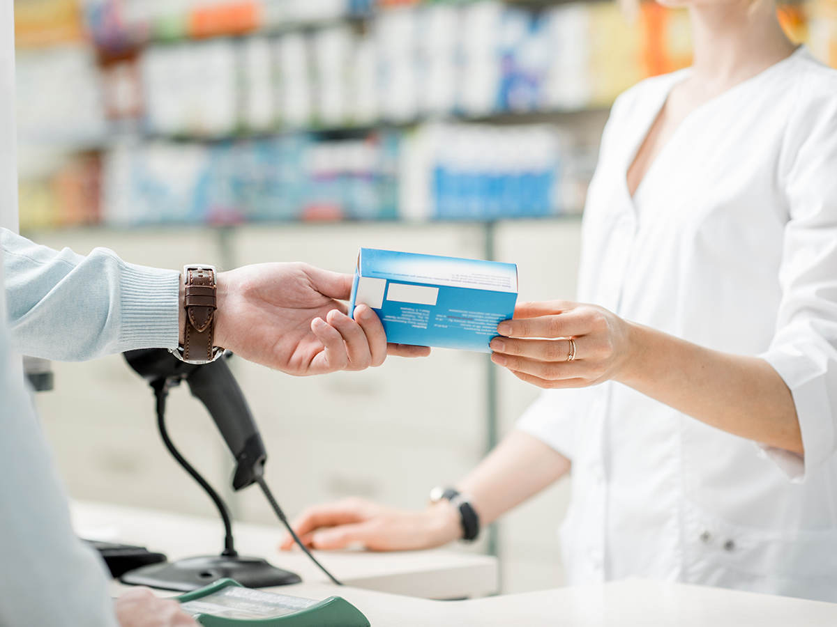 Person purchasing medicine at a pharmacy