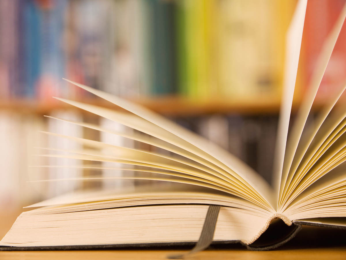 Book laying open on a table in a library