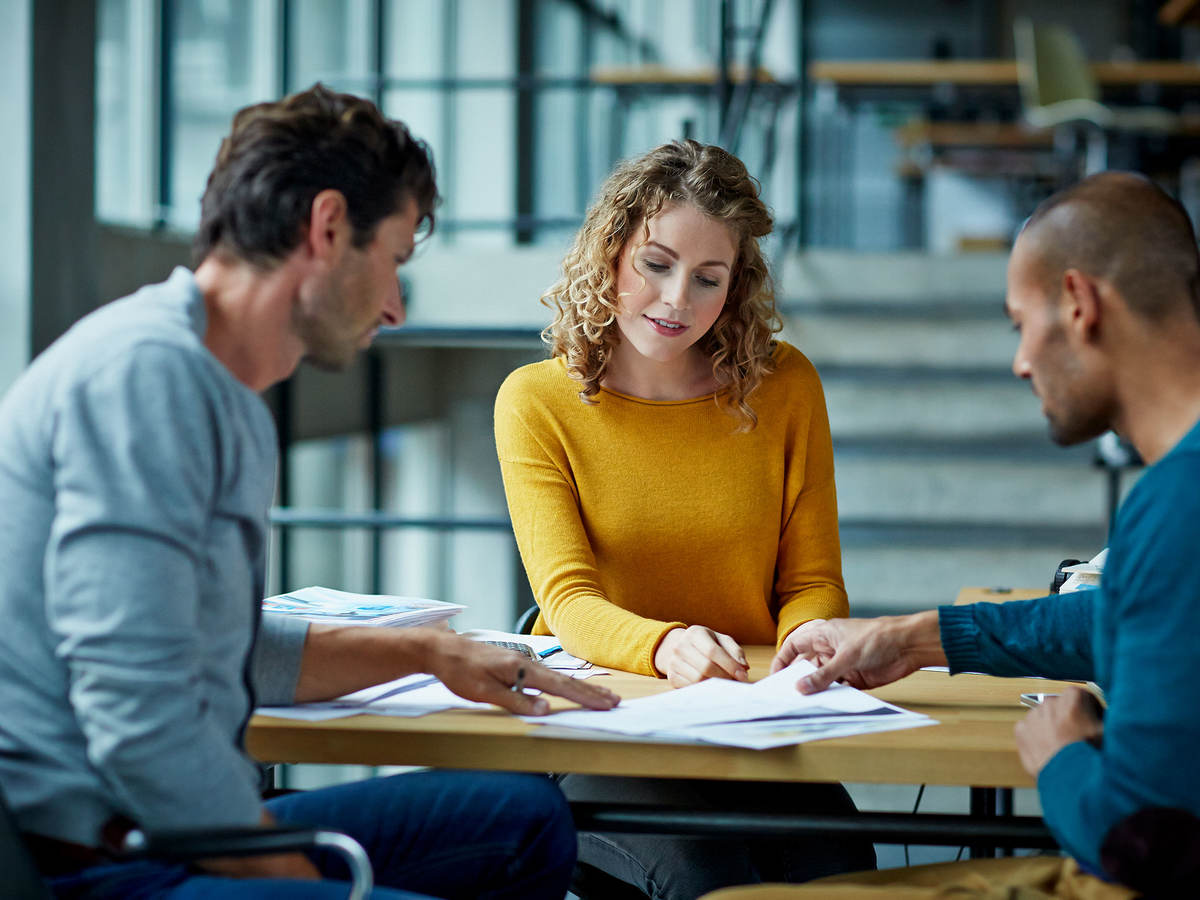 Three people at a table collaborating