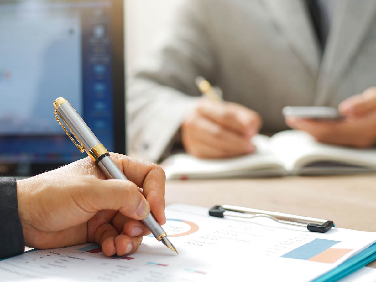 Two people taking notes