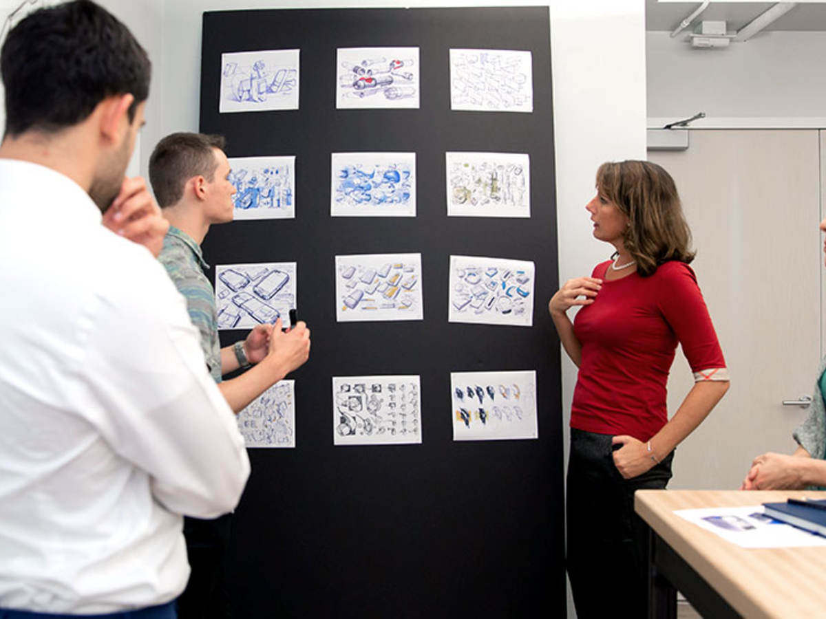 People reviewing plans on a wall