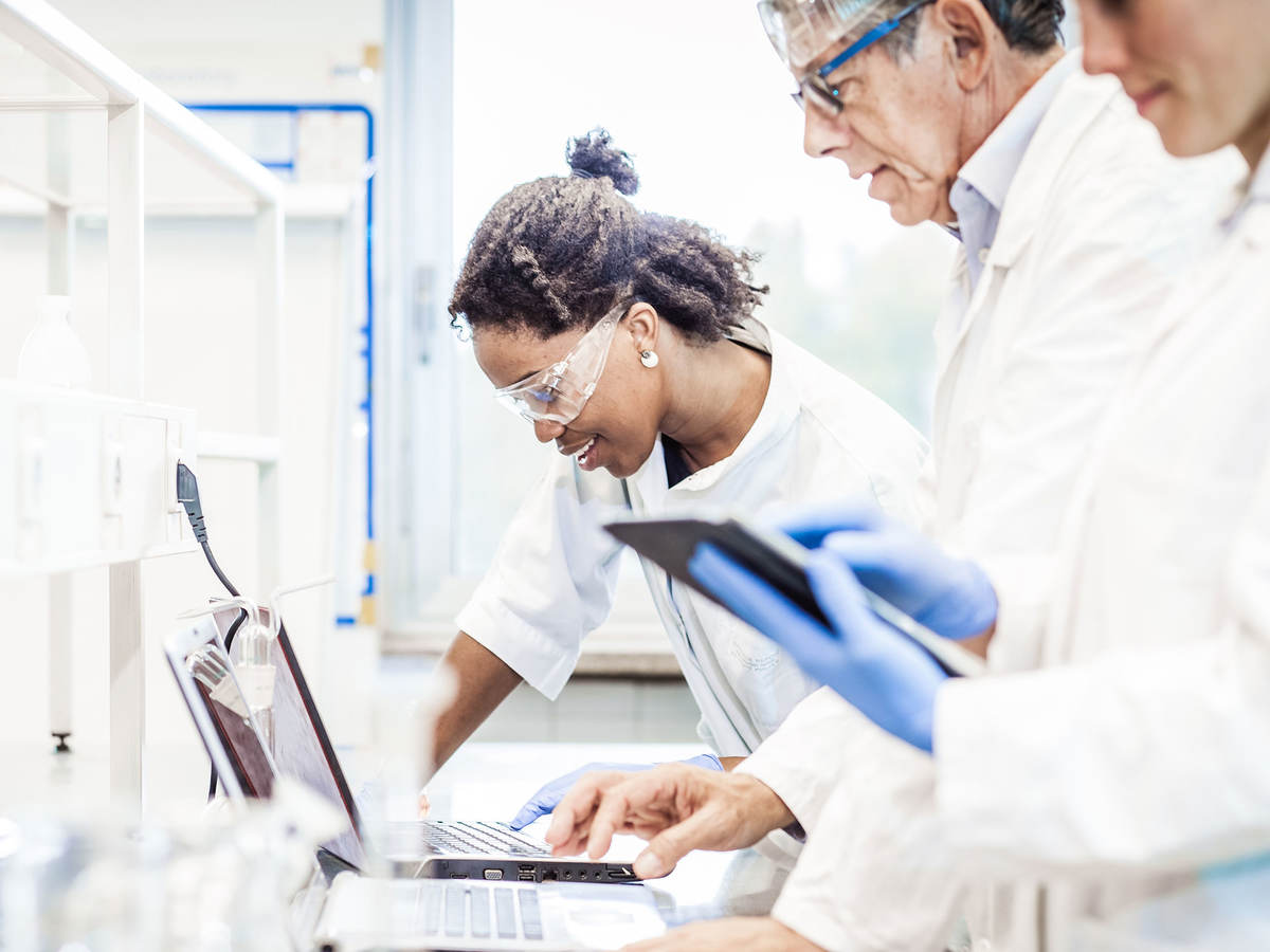 Lab techs working on a laptop