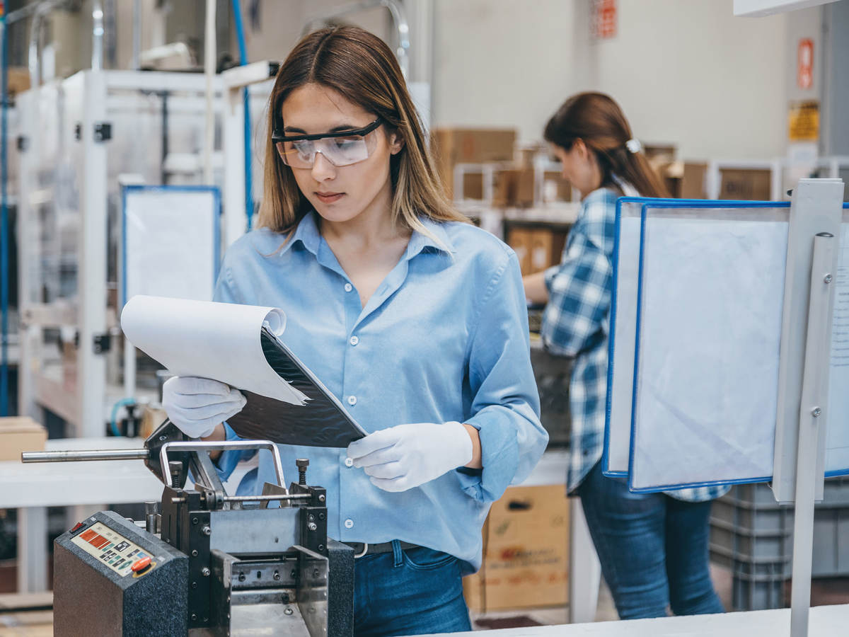 Technician in a lab reviewing notes