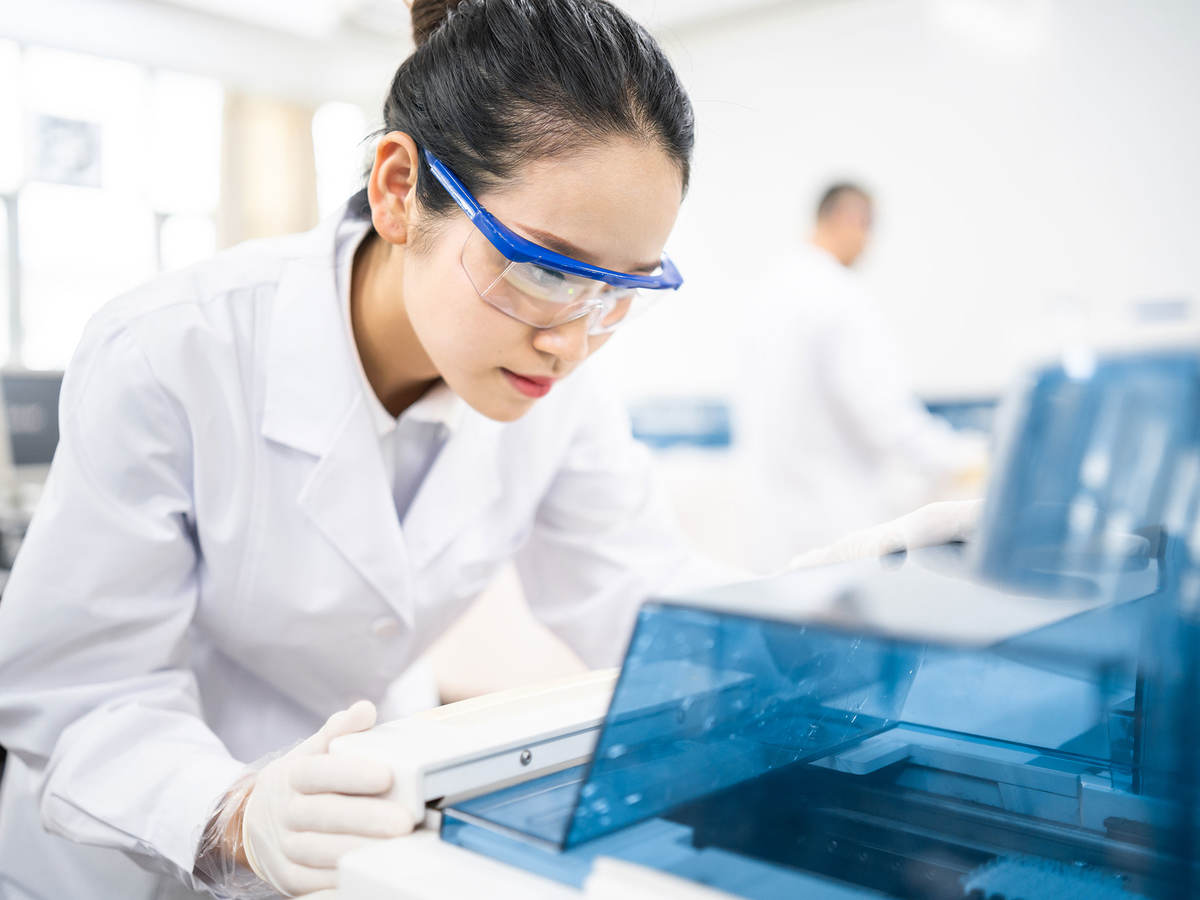 Lab technician wearing safety goggles staring at a test