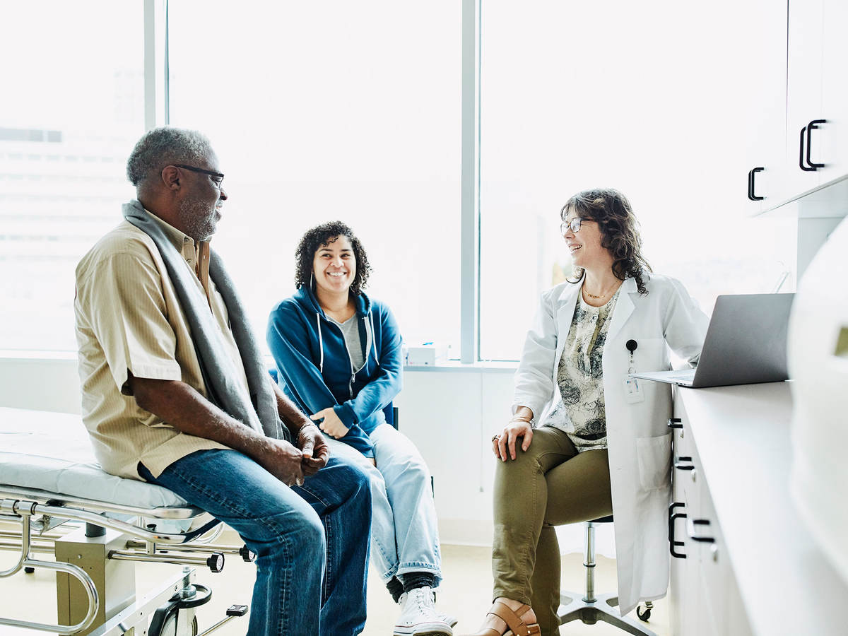 People sitting in a room with a doctor