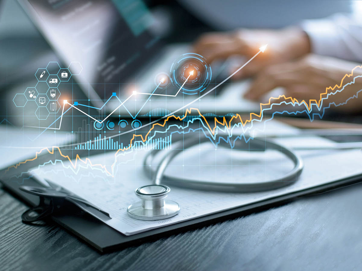 Charts and graphs superimposed over an a medical desk