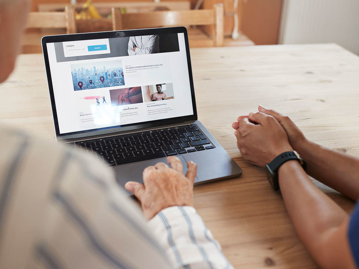 Two people using a laptop